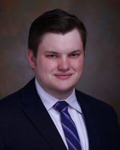 Man in suit with patterned tie.